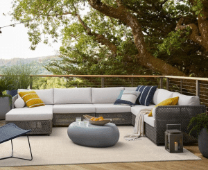 Outdoor rug with sectional couch and chairs on a patio
