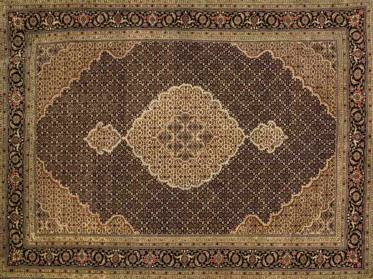 Handmade Iranian carpet with intricate floral medallion pattern, available at Shenasi Carpet in North Vancouver